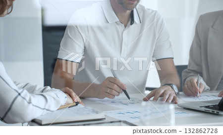 Professional team analyzing financial charts, working together in sleek workspace, strategizing company performance with collaborative energy and shared insights, close up Professional team analyzing financial charts, working together in sleek workspace, strategizing company performance with collaborative energy and shared insights, close up 132862728