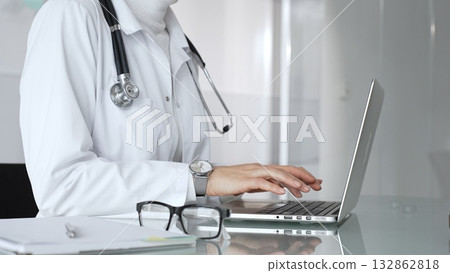 Healthcare professional working on laptop, providing digital medicine consultation and tele health service. Medicine, healthcare and science concept Healthcare professional working on laptop, providing digital medicine consultation and tele health service. Medicine, healthcare and science concept 132862818