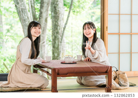 Young Asian woman on a girls trip to a ryokan or hot spring inn (travel, Japanese-style room, veranda) Young Asian woman on a girls trip to a ryokan or hot spring inn (travel, Japanese-style room, veranda) 132862853