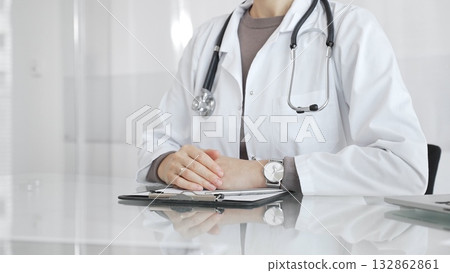 Doctor discussing medical treatment with patient during healthcare consultation, offering advice in clinic. Medicine and health care Doctor discussing medical treatment with patient during healthcare consultation, offering advice in clinic. Medicine and health care 132862861