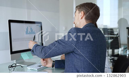 Business professionals analyzing financial data, discussing market trends, and collaborating on a project in the office. Businesspeople concept Business professionals analyzing financial data, discussing market trends, and collaborating on a project in the office. Businesspeople concept 132862903