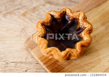 coffee Portuguese sweet dessert egg tart on wooden table. 132864434