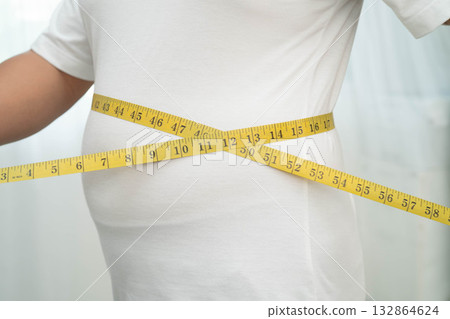 Asian woman with fat belly big size overweight and obesity with measure tape. 132864624