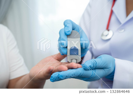 Doctor check diabetes from finger blood sugar level with finger lancet. Doctor check diabetes from finger blood sugar level with finger lancet. 132864646