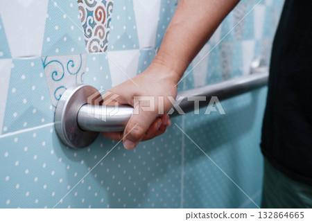 Asian elderly old woman patient use toilet support rail in bathroom, handrail safety grab bar, security in nursing hospital. Asian elderly old woman patient use toilet support rail in bathroom, handrail safety grab bar, security in nursing hospital. 132864665