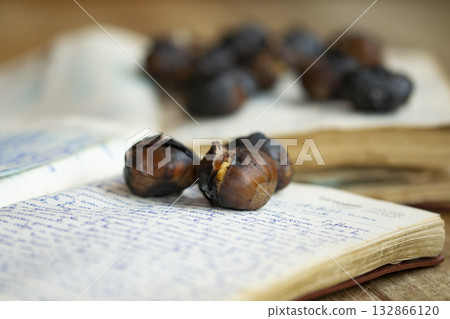 roasted chestnuts on an old manuscript roasted chestnuts on an old manuscript 132866120