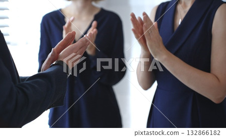 Business people hands clapping, showing applause and appreciation for success and achievement during a corporate event or conference meeting in bright office with sun flair Business people hands clapping, showing applause and appreciation for success and achievement during a corporate event or conference meeting in bright office with sun flair 132866182