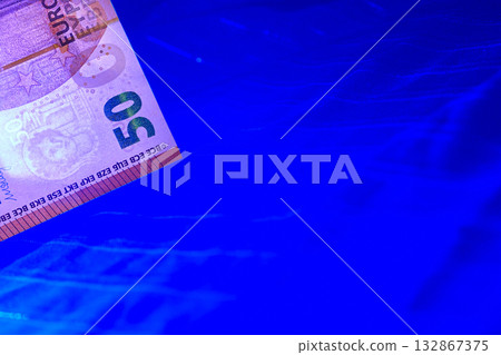 Checking money. 50 euro banknote on dark blue Checking money. 50 euro banknote on dark blue 132867375
