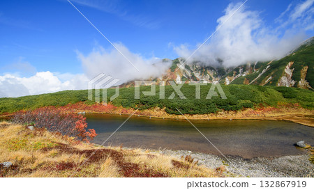 Spectacular autumn view of Midorigaike Pond and the Tateyama Mountain Range, Tateyama Kurobe Alpine Route, Murododaira, Toyama Prefecture Spectacular autumn view of Midorigaike Pond and the Tateyama Mountain Range, Tateyama Kurobe Alpine Route, Murododaira, Toyama Prefecture 132867919