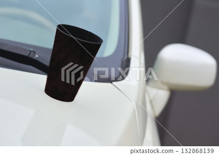 Tea time coffee break. Paper cup of coffee, tea on the hood of the car Tea time coffee break. Paper cup of coffee, tea on the hood of the car 132868139