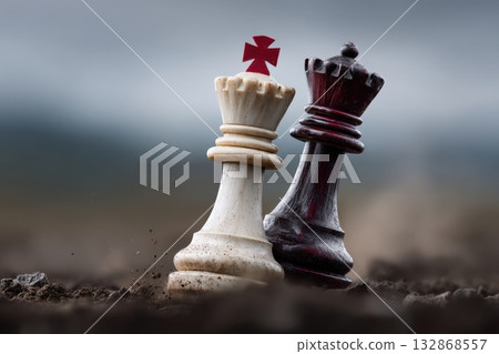 Surreal clash of chess pieces on an abstract battlefield under a moody sky 132868557