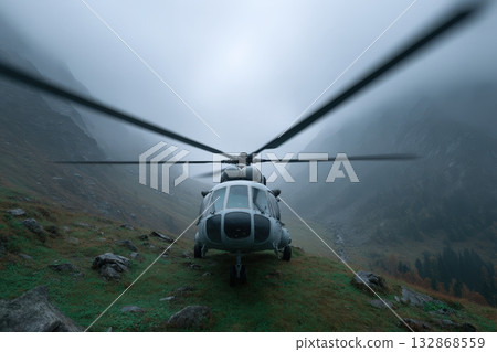 Helicopter blades stretch across a foggy mountain landscape in the early morning light 132868559
