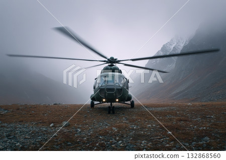 Helicopter blades spin in misty mountain landscape during overcast conditions 132868560