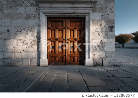 Wooden door with intricate carvings and rustic charm on a beautiful stone building 132868577