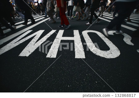 Busy city street captures the energy of pedestrians crossing at a vibrant urban intersection 132868817