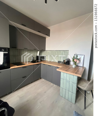 Modern Kitchen: Stylish Gray Cabinets and Wood Accents Modern Kitchen: Stylish Gray Cabinets and Wood Accents 132868872