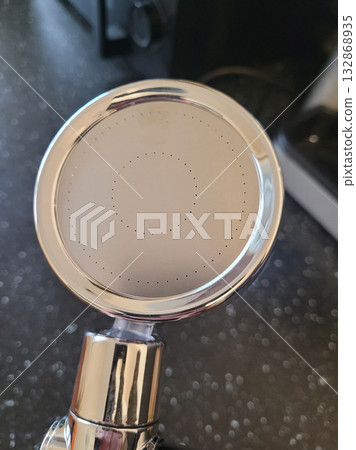 Holding a Golden Turbine Shower Head 132868935