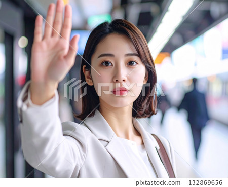 A young woman waving a hand 132869656