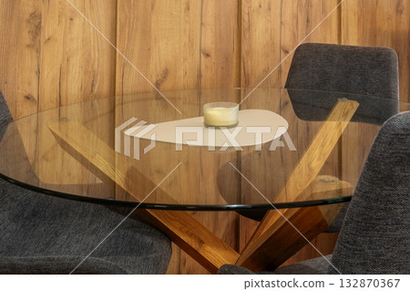 A glass table with a candle A glass table with a candle 132870367