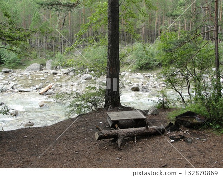 A turbulent stream of clear water from the high mountains continues its movement over the rocks  132870869