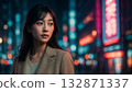 Cinematic portrait of a woman standing in a neon-lit city at night 132871337