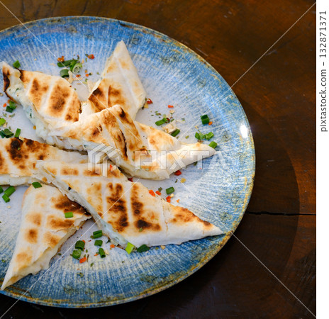 Grilled cheese triangles of grilled triangle sandwiches with cheese and sausage on a plate on a table top view Grilled cheese triangles of grilled triangle sandwiches with cheese and sausage on a plate on a table top view 132871371