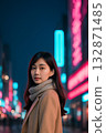 Portrait of a woman in winter clothes with a neon cityscape in the background 132871485