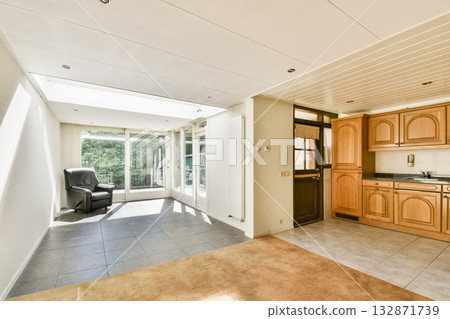 A modern interior featuring sleek furniture, an open layout, and natural light streaming through large windows, creating a warm and inviting atmosphere. A modern interior featuring sleek furniture, an open layout, and natural light streaming through large windows, creating a warm and inviting atmosphere. 132871739