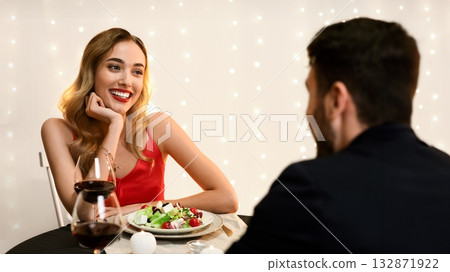 Young couple at restaurant having romantic dinner, chatting and enjoying time with each other, selective focus on happy woman Young couple at restaurant having romantic dinner, chatting and enjoying time with each other, selective focus on happy woman 132871922