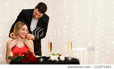 Romantic Gift. Loving Boyfriend Presenting Golden Necklace To His Girflriend For Valentine's Day At Dinner In Restaurant, Free Space Romantic Gift. Loving Boyfriend Presenting Golden Necklace To His Girflriend For Valentine's Day At Dinner In Restaurant, Free Space 132871983