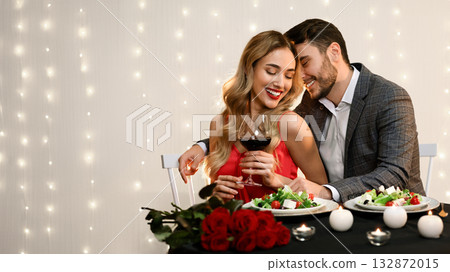 Passionate couple dining in restaurant, drinking wine and having romantic moments, free space 132872015