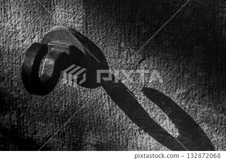 Metal hooks create unique light and shadow effects on the stone wall. 132872068