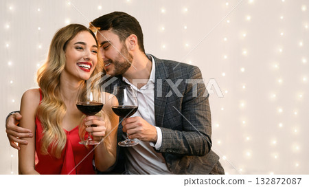 Affectionate man whispering love words to his girlfriend on date in restaurant, romantic couple having Valentine dinner together 132872087