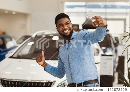 New Car. Happy Auto Buyer Man Making Selfie Near His Automobile Gesturing Thumbs-Up In Dealership Center. New Car. Happy Auto Buyer Man Making Selfie Near His Automobile Gesturing Thumbs-Up In Dealership Center. 132872239