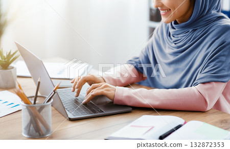 Smiling Arabic Woman Working On Laptop For New Project At Workplace In Office, Cropped Image With Copy Space. 132872353