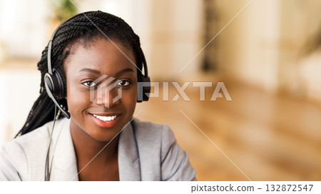 Call center operator. Portrait of smiling african american woman in headset, closeup Call center operator. Portrait of smiling african american woman in headset, closeup 132872547