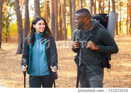 Multiracial group of young hikers having fun while backpacking at forest 132872628