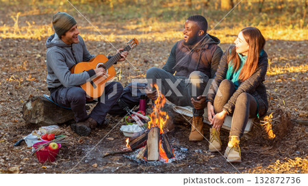 International group of people camping and singing in autumn forest, copy space International group of people camping and singing in autumn forest, copy space 132872736