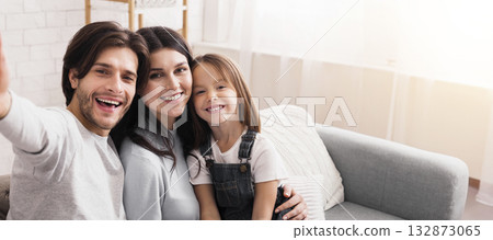 Capturing Happy Moments. Self-Portrait Of Millennial Parents With Cute Little Daughter Posing For Selfie At Home, Closeup 132873065