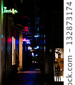 Neon signs of bars lining the back alleys 132873174