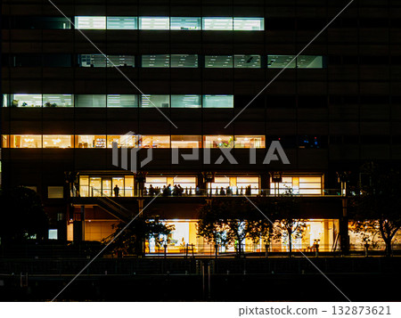 A figure reflected in the window of a building along a canal A figure reflected in the window of a building along a canal 132873621