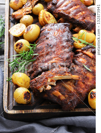 bbq baby pork ribs with potatoes, fresh rosemary bbq baby pork ribs with potatoes, fresh rosemary 132873941