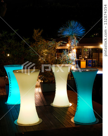 A stylish, luminous bar stand table 132874354