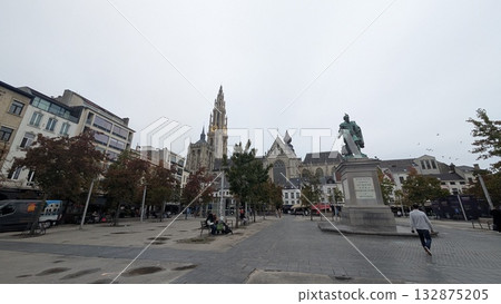 A sculpture and a cathedral view at the square in Antwerp 132875205