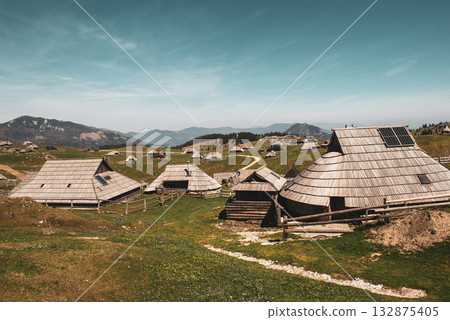 Mountain village in Alps, wooden houses in traditional style, Velika Planina, Kamnik, Slovenia Mountain village in Alps, wooden houses in traditional style, Velika Planina, Kamnik, Slovenia 132875405