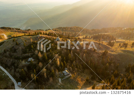 Mountain village in Alps, wooden houses at sunset, Velika Planina, Kamnik, Slovenia Mountain village in Alps, wooden houses at sunset, Velika Planina, Kamnik, Slovenia 132875416