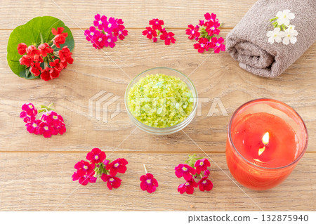Towel with body care products and verbena flowers on the wooden background. 132875940