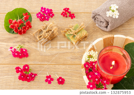 Towel with body care products and verbena flowers on the wooden background. 132875953