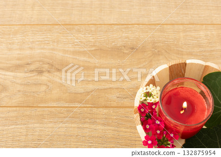 Candle in the wooden basket. 132875954