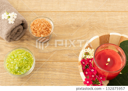 Towel with body care products on the wooden background. 132875957